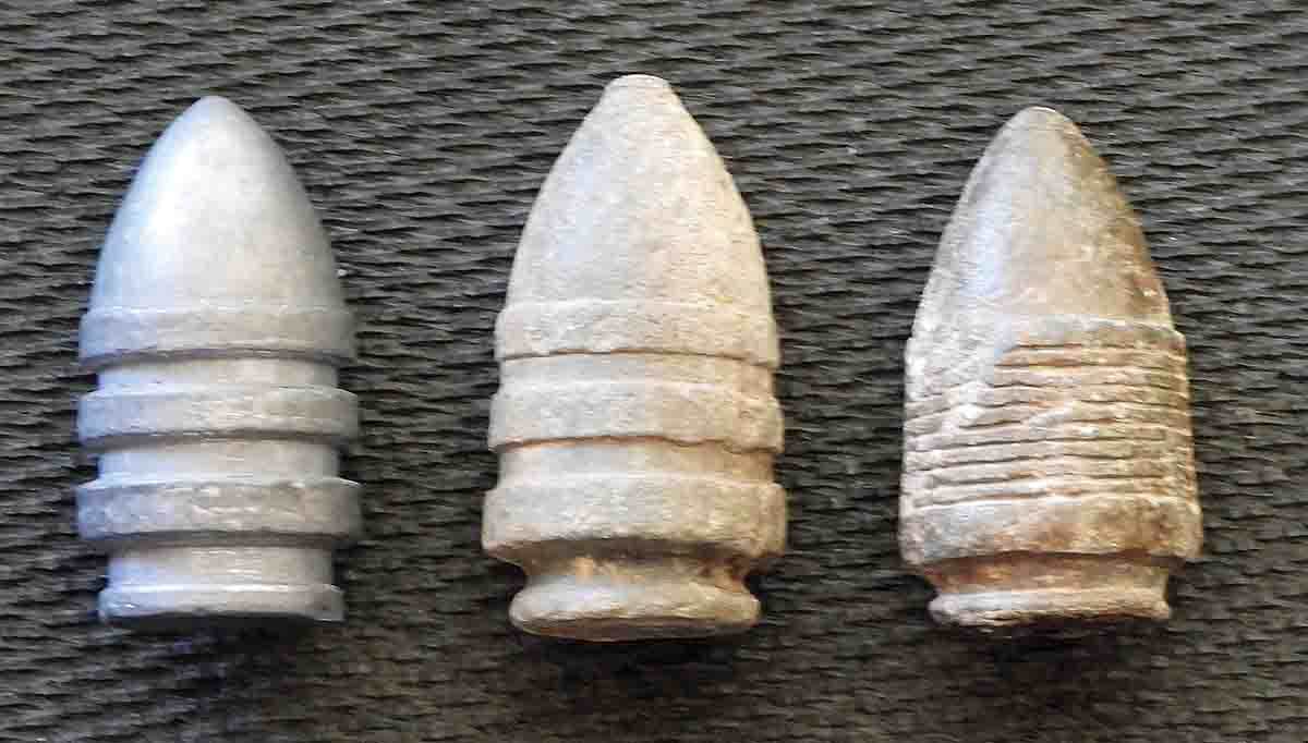 Test bullet shown along with two types of original bullets. The three-band in the center is the most common for this era, with the bullet on the right being the rare Gomez & Mills multi-groove.
